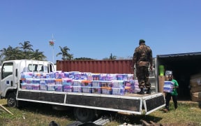 Supplies from New Zealand are unloaded in Vanuatu.