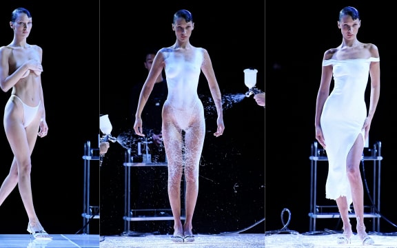 (COMBO) This combination created on October 1, 2022, of pictures taken on September 30, 2022, shows US model Bella Hadid receiving Fabrican Spray-on fabric to create a dress during the Coperni Spring-Summer 2023 fashion show as part of the Paris Womenswear Fashion Week, in Paris. (Photo by JULIEN DE ROSA / AFP)