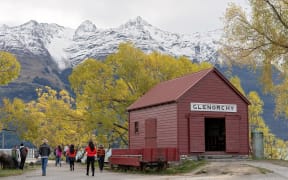 GLENORCHY, NEW ZEALAND - APRIL 2018: Tourists visiting the famed red hut at Glenorchy on the banks of Lake Wakatipu