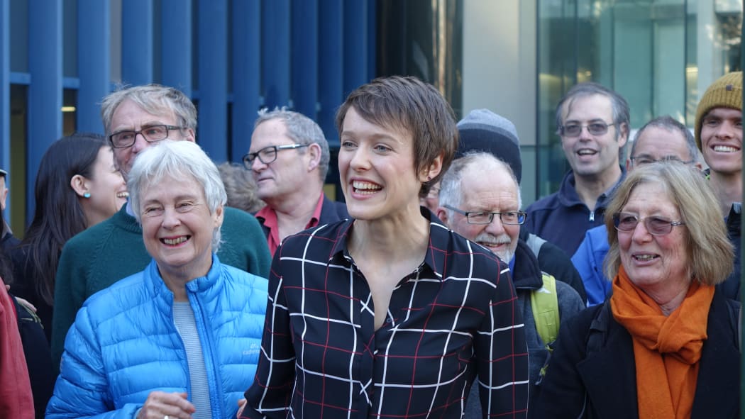 Sarah Thomson, at centre, with supporters outside the High Court in Wellington.