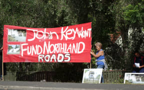 Members of the Pipiwai-Titoki rural roads advocacy group outside Northland Polytechnic in Kerikeri, during a speech by Prime Minister John Key.