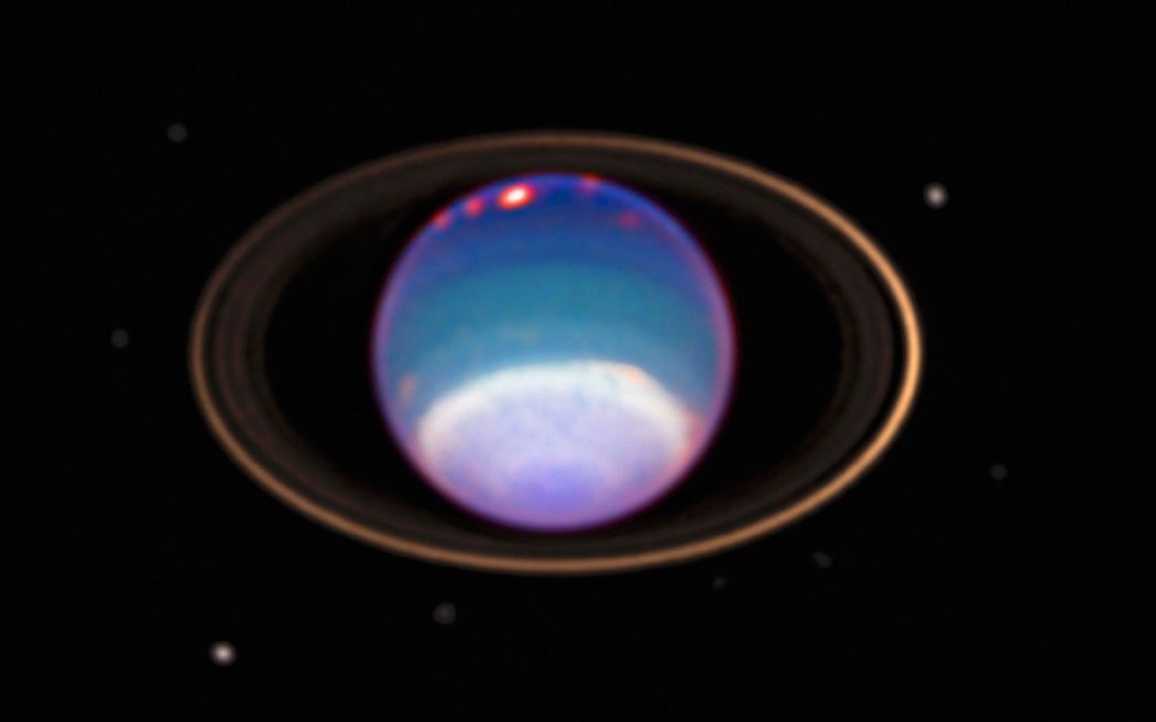 Une image d'Uranus obtenue par le télescope Hubble.  Première planète découverte, repérée pour la première fois par William Herschel en 1781 Crédit NASA (Photo by Anne Ronan Photo Library/Ann Ronan Photo Library/Photo12 via AFP)