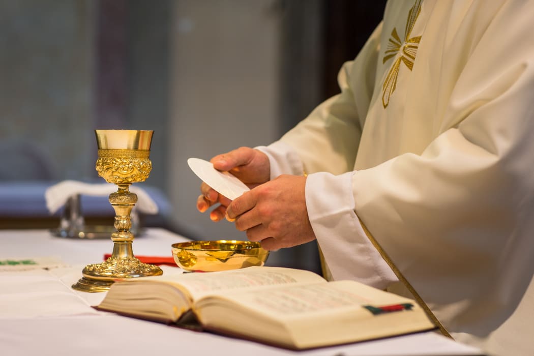 Bread and wine are used to celebrate the Eucharist during Roman Catholic masses. Here, a priest holds a wedding ceremony mass.