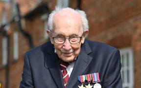 In this file photo taken in April 2020,  British World War II veteran Captain Sir Tom Moore is pictured during a lap of his garden in the village of Marston Moretaine, 50 miles north of London.