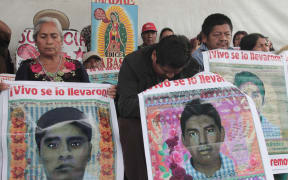 Relatives of the 43 missing students from Ayotzinapa protest at Zocalo Square in Mexico City.
