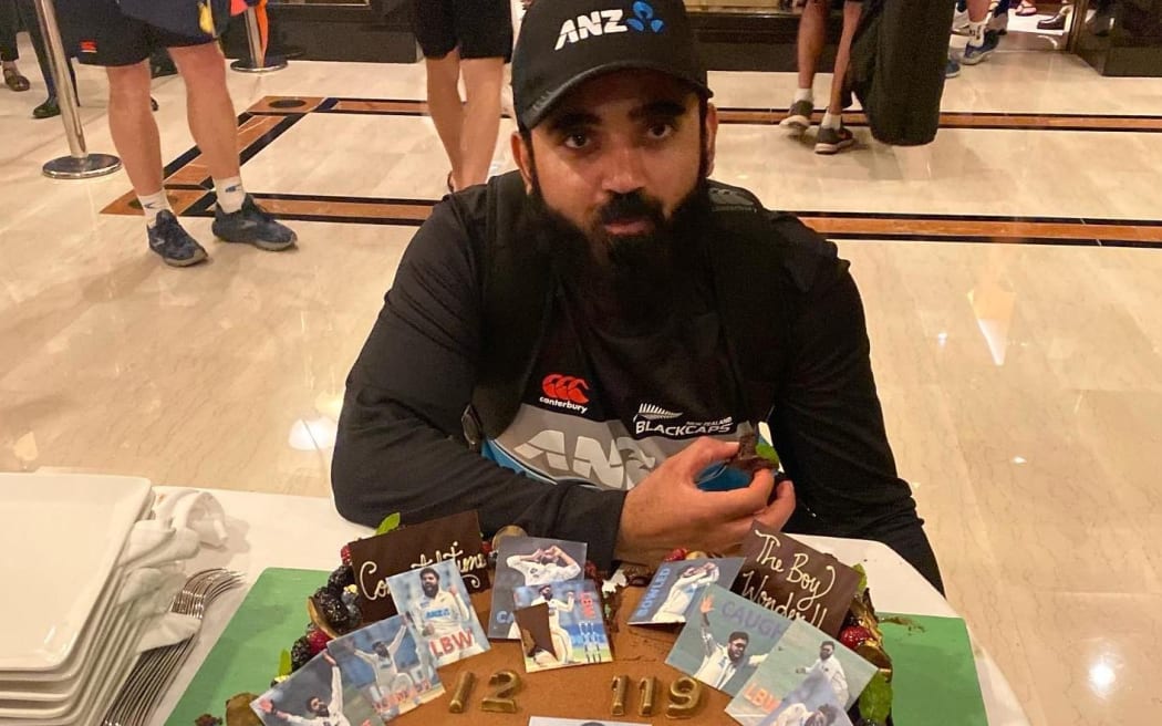 Ajaz Patel enjoys the cake hotel staff made for him to celerbrate his ten wicket achievement in Mumbai.