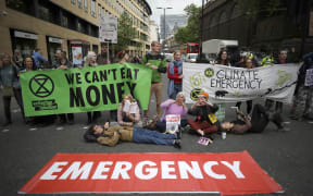 Extinction Rebellion climate change protesters briefly block the road in London, on 25 April, 2019.