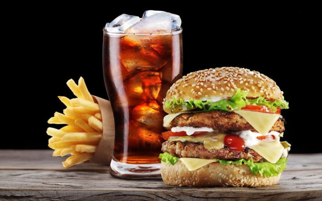 A burger, cola drink and fries.