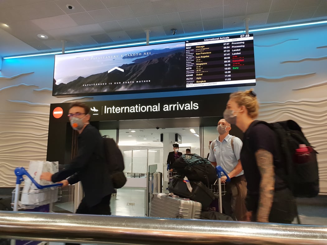 Travellers with face masks at Auckland Airport international arrivals during the Covid-19 coronavirus outbreak on 20/3/2020.