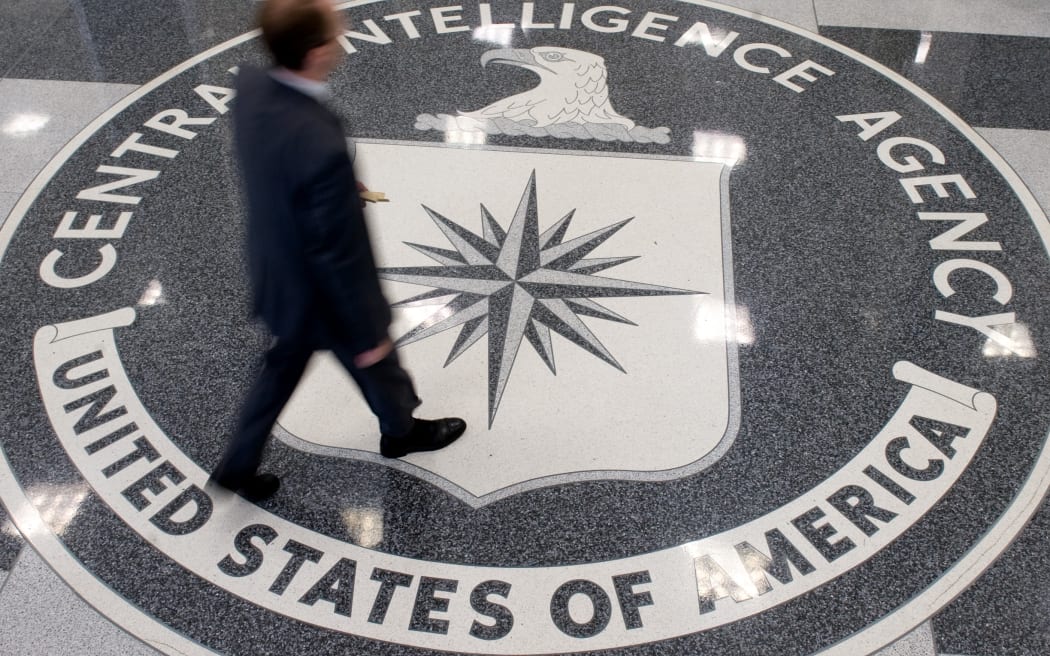 A man crosses the Central Intelligence Agency (CIA) seal in the lobby of CIA Headquarters in Langley, Virginia, on August 14, 2008.