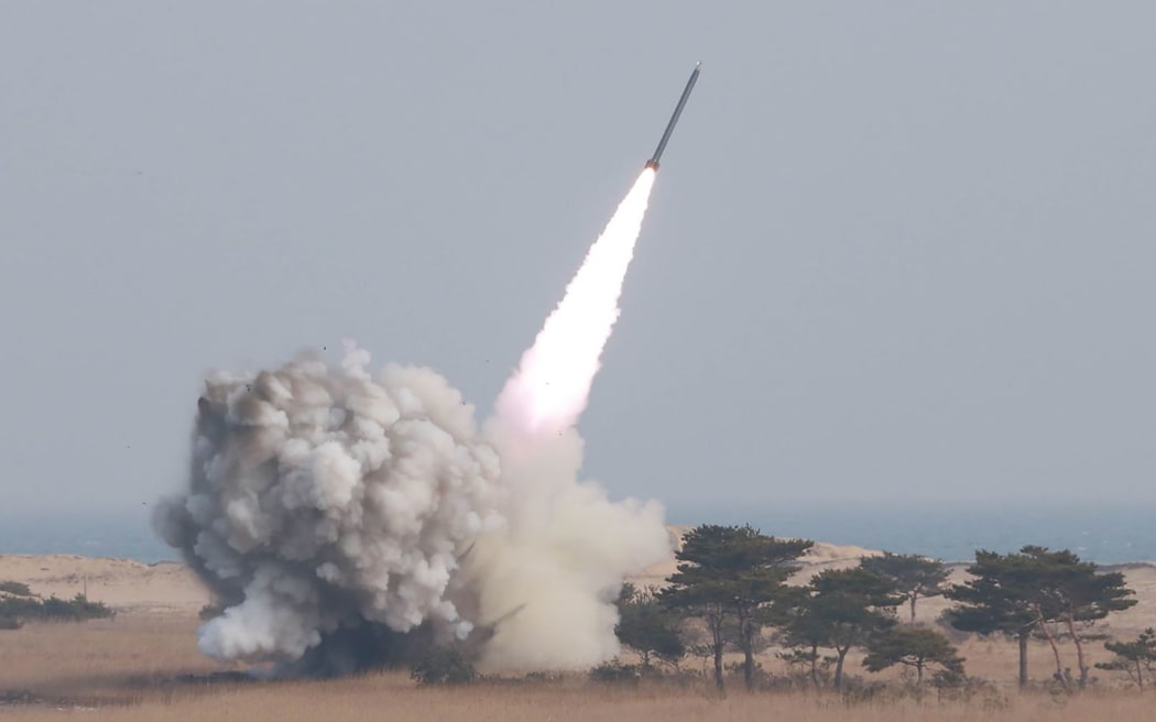 This undated picture released from North Korea's official Korean Central News Agency (KCNA) on 4 March, shows a test-fire of the new large-caliber rocket at an undisclosed location.