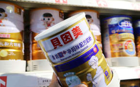 A customer shops for a tin of Beingmate 'mommy' formula in Xuchang, China.