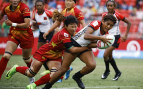 PNG's Helen Abau is tackled by China's Wang YueYue in the 11th place playoff.