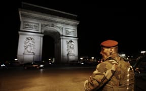 A soldier stand guards near the Arc de Triomphe after a shooting at the Champs Elysees in Paris on April 20, 2017.