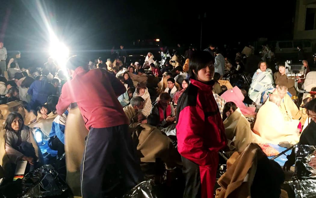 People gather outside the Mashiki town hall after the 6.2 quake.
