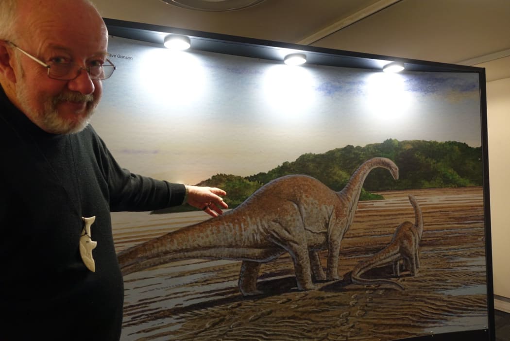 Nelson Provincial Museum chief executive Peter Millward points out an artist's impression of the type of dinosaur that once strolled around northwest Nelson.