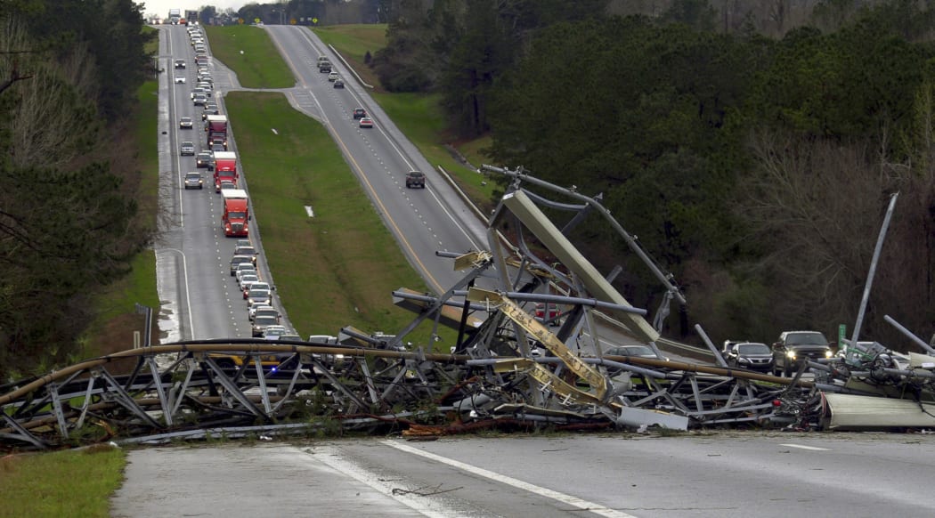 A fallen cell tower lies across U.S. Route 280 highway in Lee County, Ala., in the Smiths Station community after what appeared to be a tornado struck in the area.