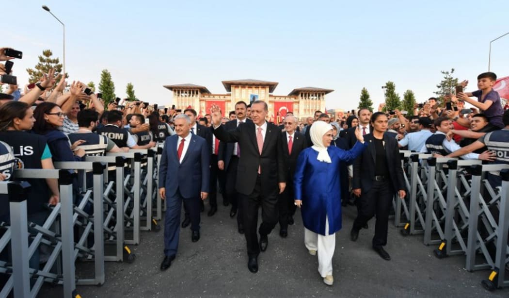 Turkish President Recep Tayyip Erdogan (C) and his wife Emine Erdogan (R) and Turkish Prime Minister Binali Yildirim (L) attending the opening ceremony of the 'July 15 Martyrs’ Monument.