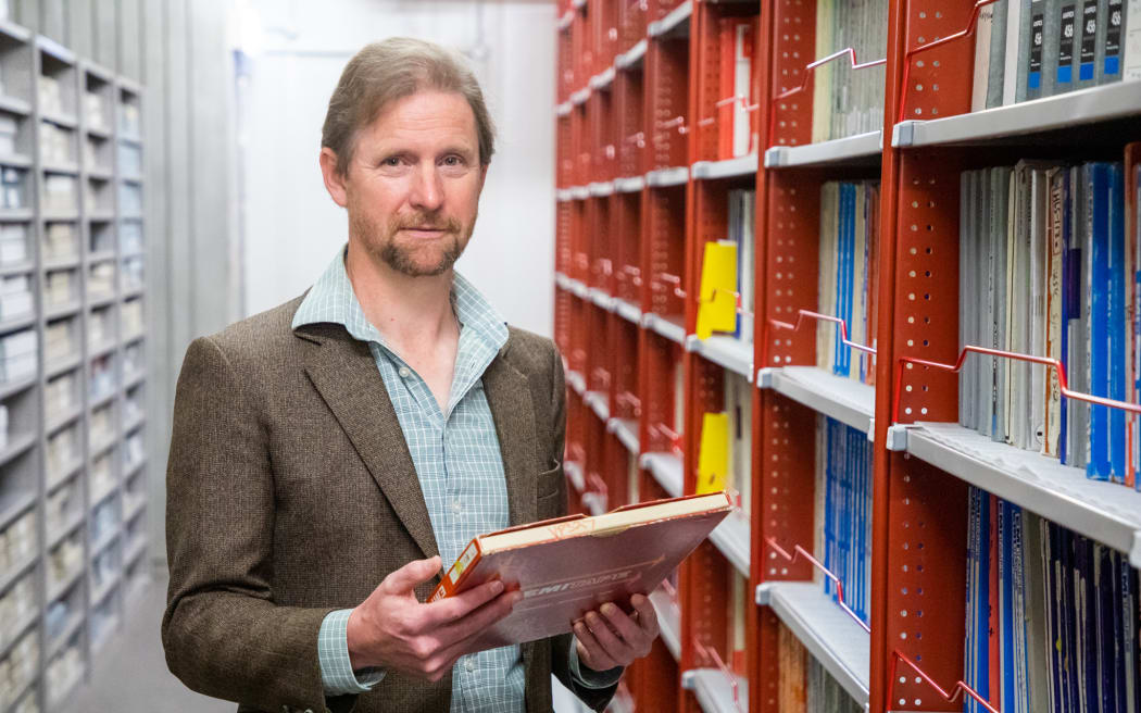 Michael Brown, music curator at the Alexander Turnbull Library, among the music collection holdings at the National Library.
