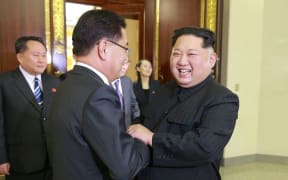 North Korean leader Kim Jong-Un (R) shakes hands with South Korean chief delegator Chung Eui-yong.