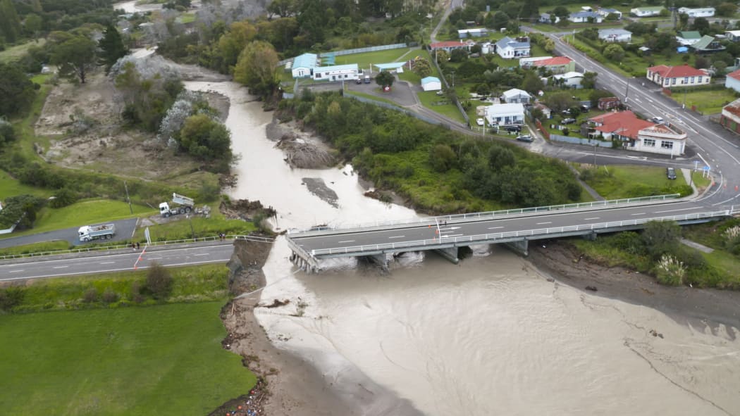 A section of the bridge in Tokomaru Bay has been wiped out by flood water, bisecting the town alongside State Highway 35