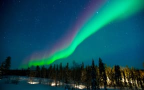 The northern lights stream across the arctic sky near Yellowknife, Northwest Territories in Canada.