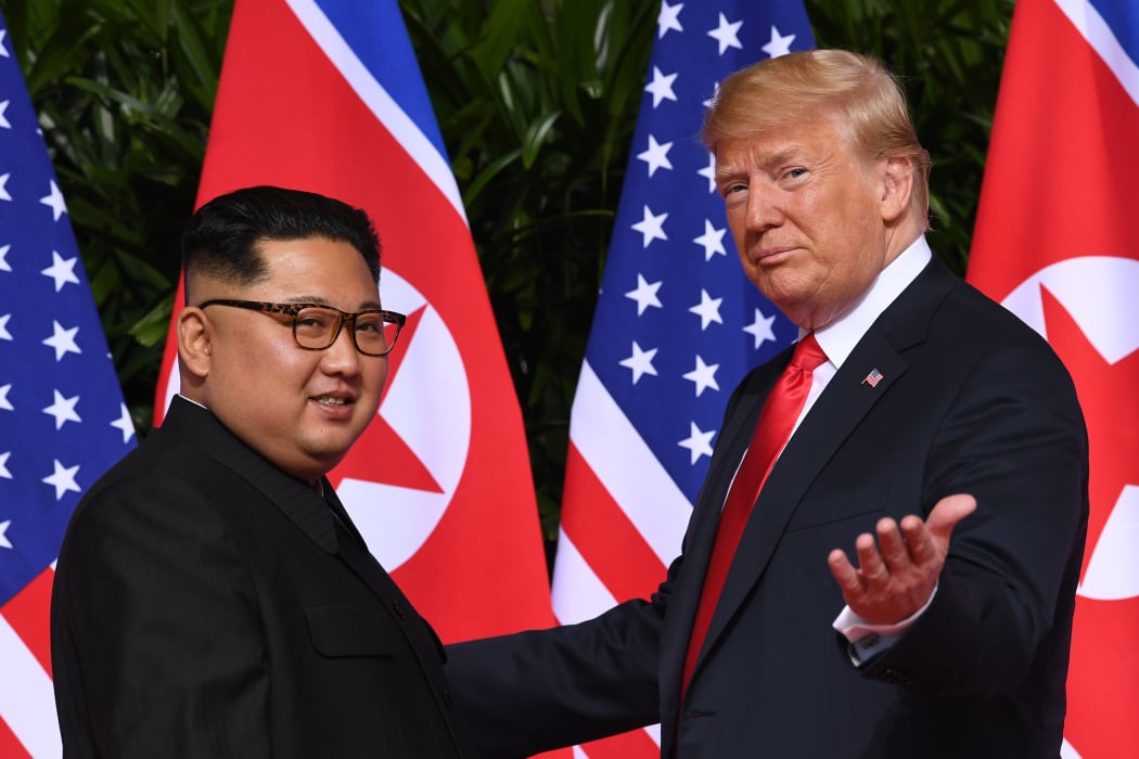 US President Donald Trump gestures as he meets with North Korea's leader Kim Jong Un at the start of their historic US-North Korea summit in 2018.