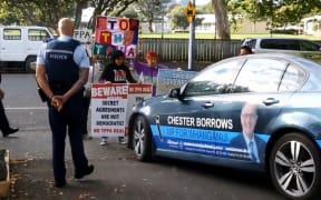 Chester Borrows was confronted by a crowd of TPP protesters on Tuesday (screenshot from video).