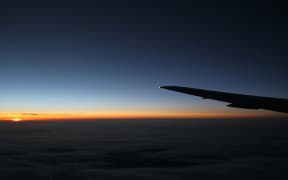 Plane wing at night with sunset (stock)