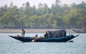 Indian Fishermen catch fishes in foggy morning on the Matla river in the Sundarban, South 24 Parganas district of West Bengal, India on Sunday , 29th December, 2019.