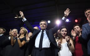 French presidential election candidate for the right-wing Les Republicains (LR) party Francois Fillon (C) gestures during a rally at the Porte de Versailles in Paris, on April 9, 2017.