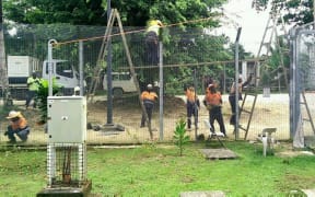 Workers taking down the fences at the Manus Island detention centre.