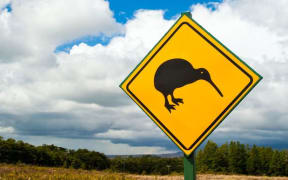 A road sign showing a Kiwi