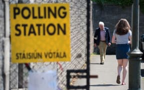 Voters arrive and leave St. Patrick's Boys National School polling station in Drumcondra, Dublin, to vote in the Irish referendum on liberalising abortion law on 25 May.