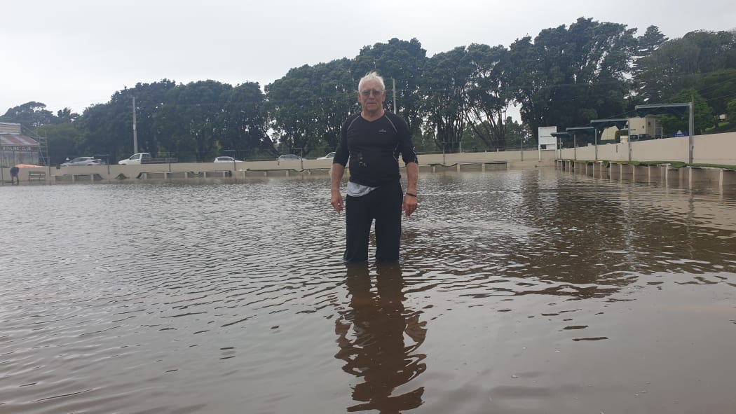 Spud Andrews takes a stroll across the flooded Paritutu Bowling Club greens.