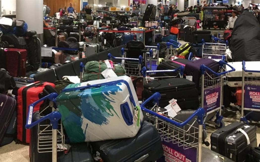 National MP Dr Shane Reti photographed baggage piled up in the arrivals hall at Auckland International Airport on December 26.