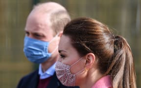 Britain's Prince William, Duke of Cambridge and Britain's Catherine, Duchess of Cambridge  gesture during a visit to School21 following its re-opening after the easing of coronavirus lockdown restrictions in east London on March 11, 2021.