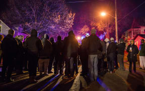 A group gathers in front of a police line after 5 people were shot at a Black Lives Matters protest November 24, 2015 in Minneapolis, Minnesota.