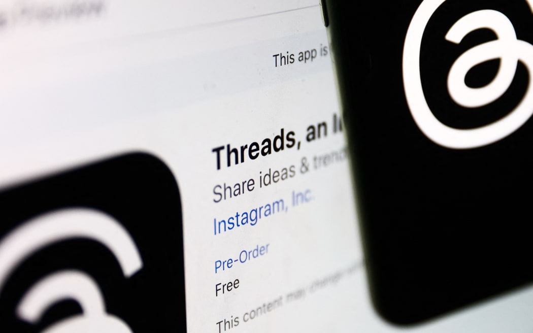 Threads on App Store displayed on a laptop screen and Threads logo displayed on a phone screen are seen in this illustration photo taken in Krakow, Poland on July 4, 2023.