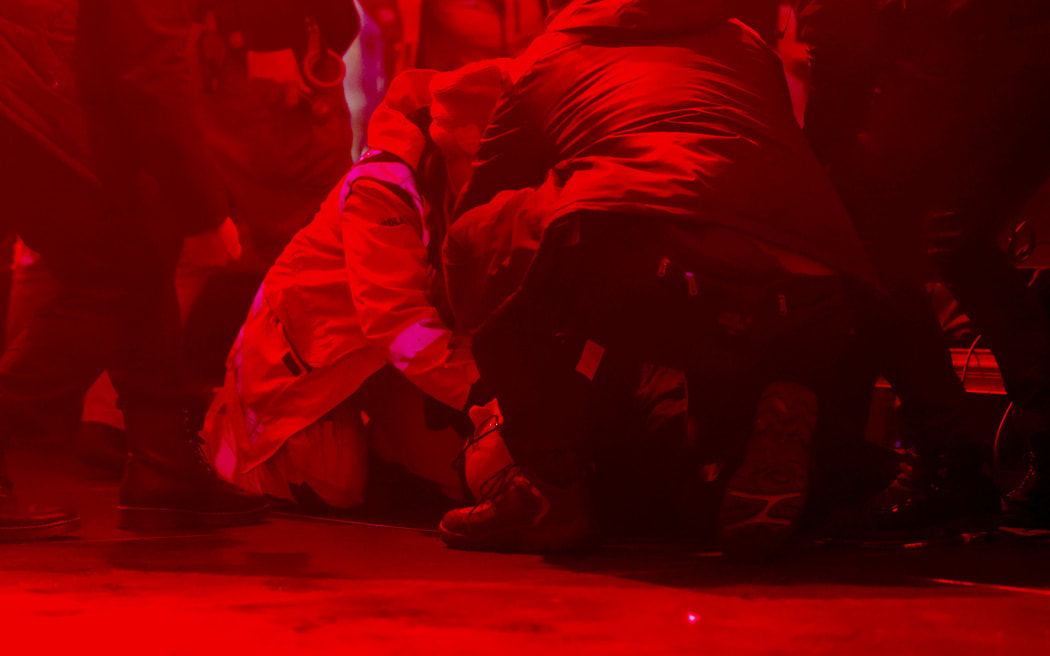 The mayor of Gdansk Pawel Adamowicz lies on the floor and is helped after being attacked during the charity event.