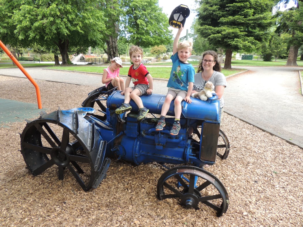 Masterton mother Abby Hollingsworth with her children Lucy, 7, Zane, 5, and Troy, 3 at the town's playground. The local district council is proposing removing the tractor and a bulldozer as they do not meet safety standards.
