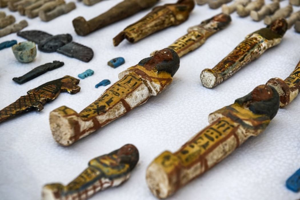 November 24, 2018: Carved wooden statues and funerary figurines called "Ushabtis" discovered at the site of Tomb TT28 at Al-Assasif necropolis on the west bank of the Nile north of the southern Egyptian city of Luxor.