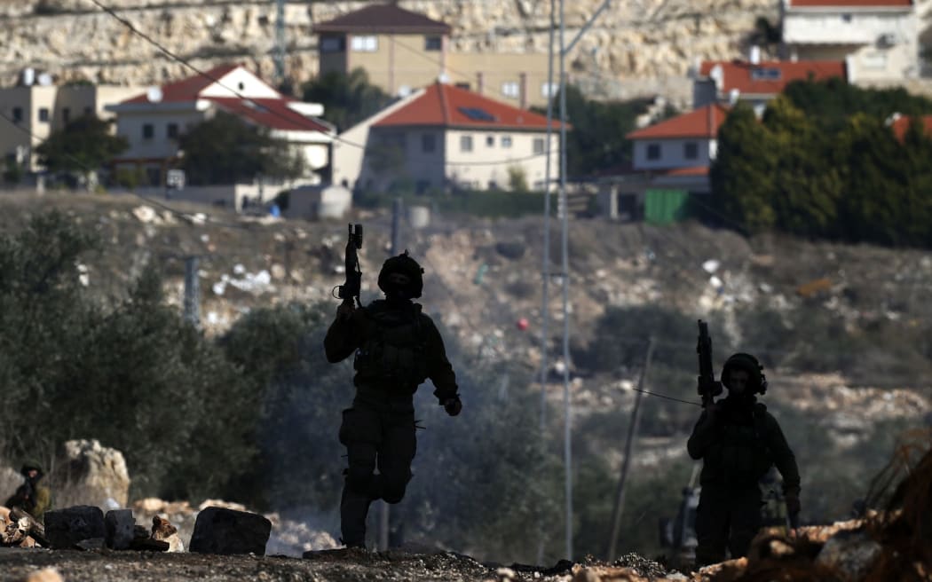 Israeli security forces taking position near the settlement of Kadumim (background) during clashes following a demonstration against the expropriation of Palestinian land by Israel.