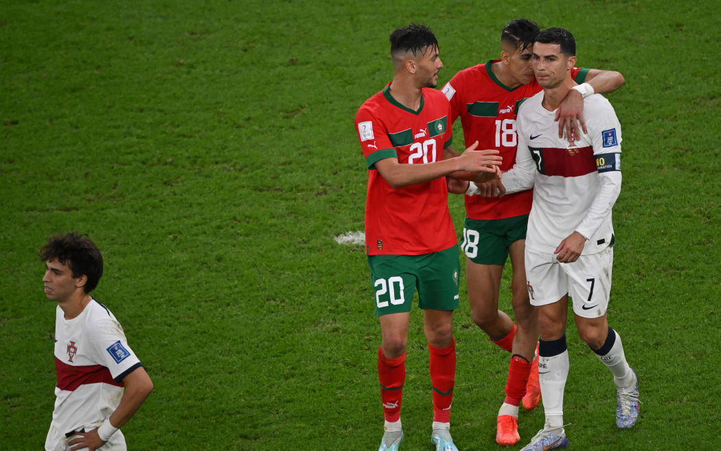 Morocco's defender Achraf Dari and Morocco's defender Jawad El Yamiq greet Portugal's Cristiano Ronaldo as he leaves the field after losing to Morocco 1-0 in the Qatar 2022 World Cup quarter-final football match between Morocco and Portugal on December 10, 2022.