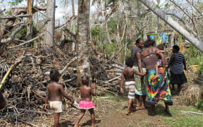 Shaline Nimal walks through what is left of the village of Rangorango on Efate island, Vanuatu.