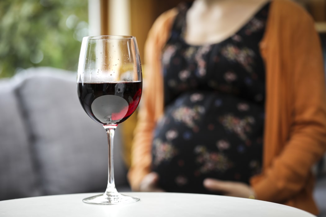 Generic pregnant woman drinking alcohol.