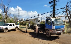 Workers from Vanuatu's electricity provider UNELCO repair power lines