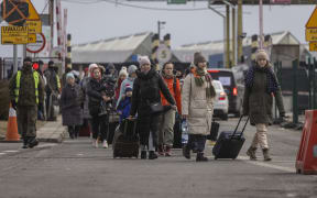 Refugees from Ukraine are pictured after crossing the Ukrainian-Polish border in Korczowa on March 02, 2022.