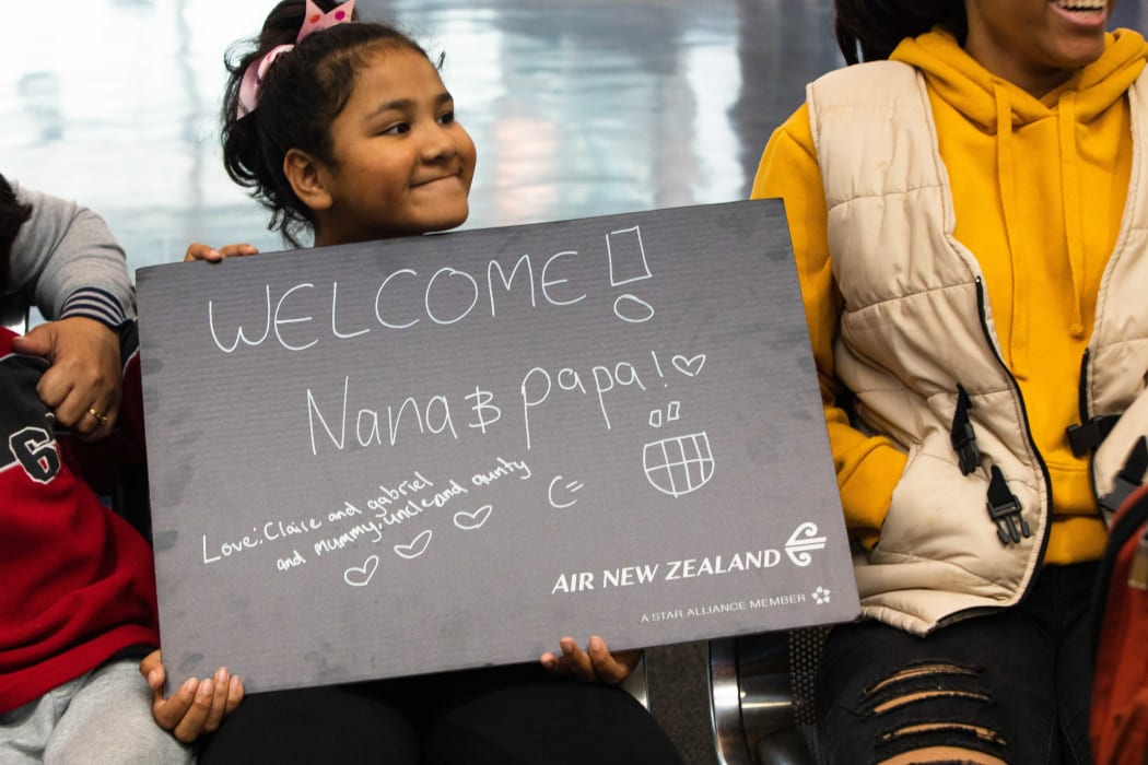 Claire holds a welcome sign as she waits at Auckland Airport for her grandparents, to come through the arrivals gate from the  Sydney to Auckland flight.
