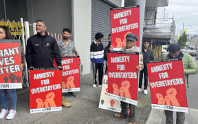 People protest over migrant worker exploitation outside Ethnic Communities Minister Priyanca Radhakrishnan's office in Auckland on Saturday.